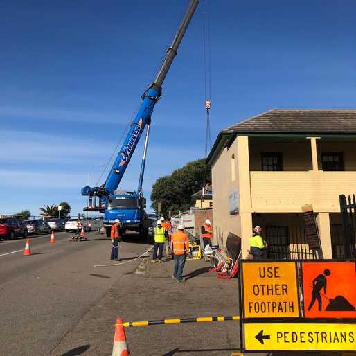Crane-lifting equipment into the James Fletcher Hospital campus, ready to start work on the heritage wall restoration.